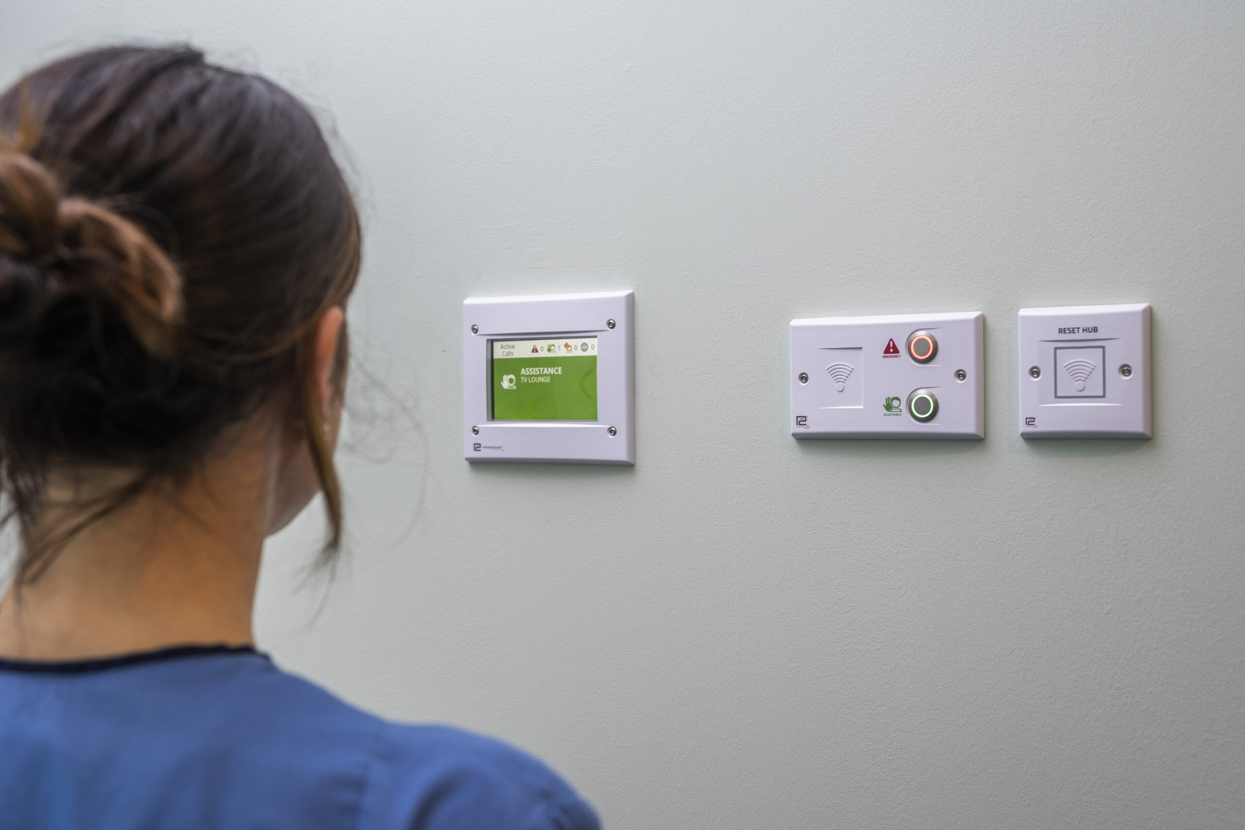 Nurse looks at active assistance alarm displayed on Pinpoint display unit