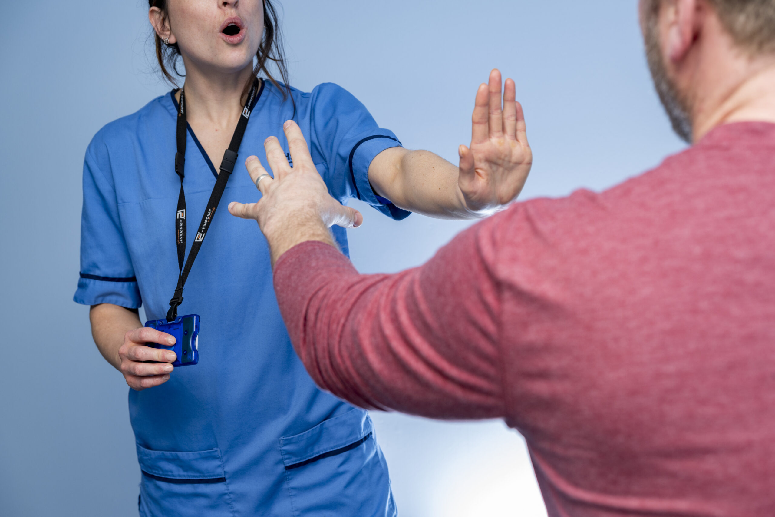 Nurse activates Pinpoint Badge PIT alarm as male makes aggressive gesture toward her.
